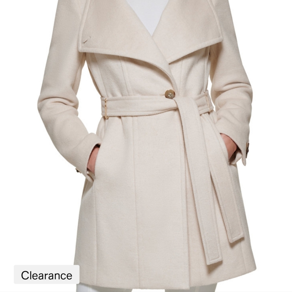 Coat was too large. Has all tags and an extra button attached inside the coat.